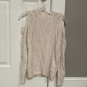 Exposed shoulder knit sweater.
